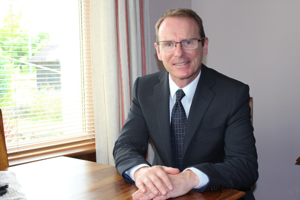 a person in a suit and tie smiling
