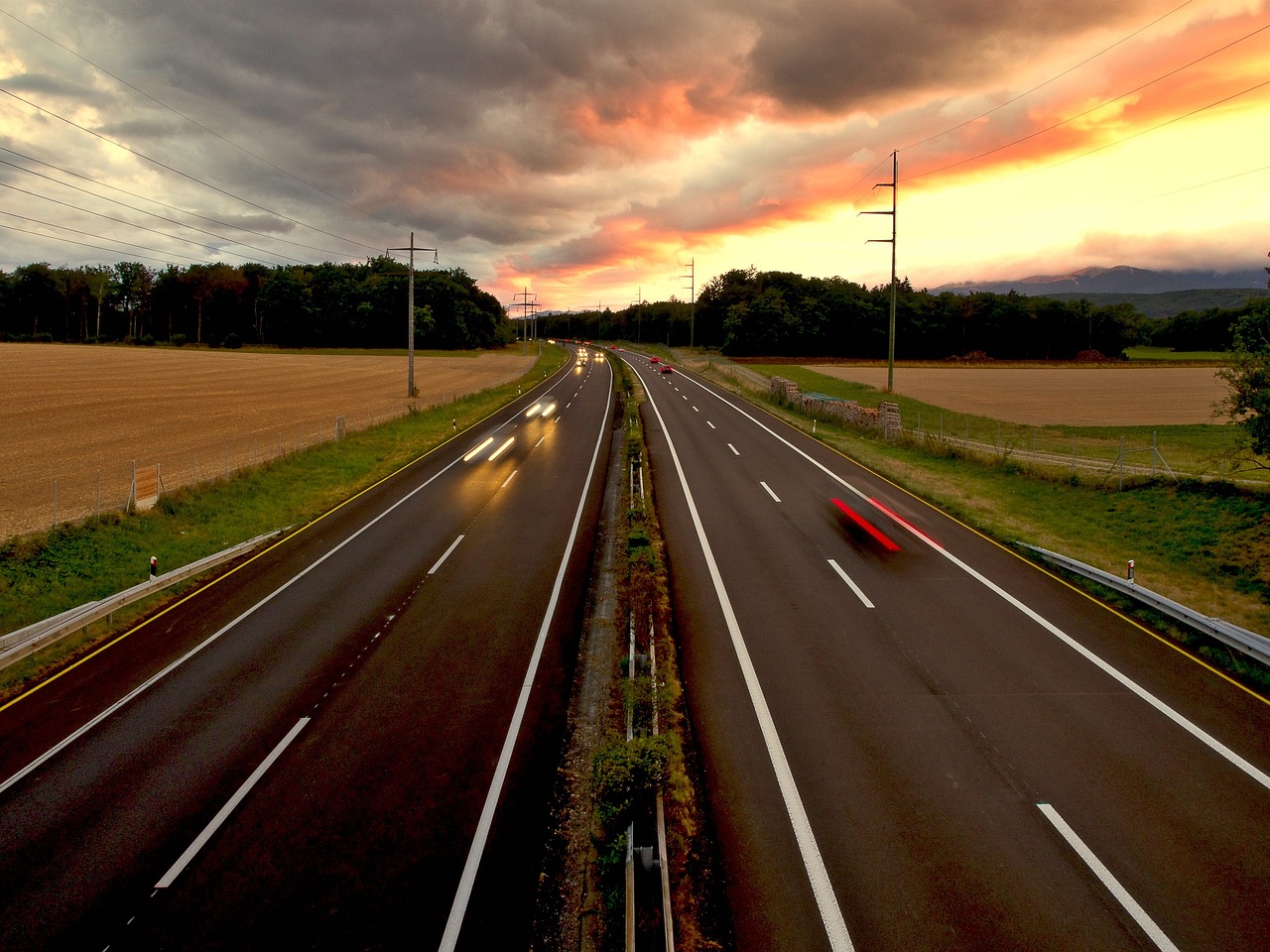 a motorway with a sunset